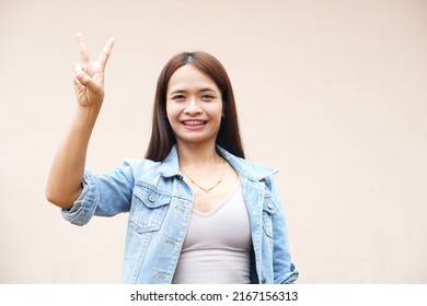 Asian Woman Holding Up Two Fingers