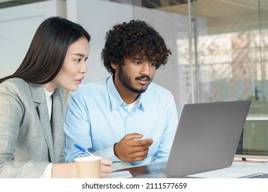 Asian Woman And Indian Man Using Laptop. Multi-ethnic Business Team Working Together Looking At Computer Screen. Interracial Student Studying Watching Online Tutorial Or Training Webinar