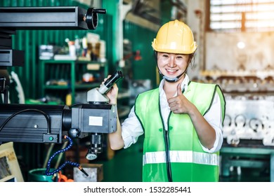 Asian Woman Is Industrial Engineer Or Qc Team Holding Th Clipboard While Standing In The Heavy Duty Manufacturing Shop Floor. Factory Worker Concept.