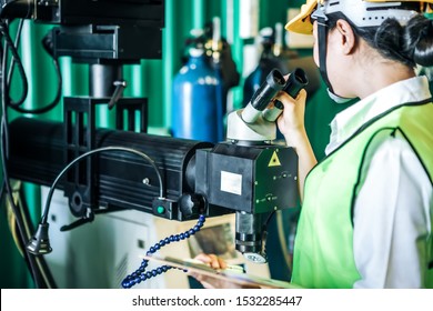 Asian Woman Is Industrial Engineer Or Qc Team Holding Th Clipboard While Standing In The Heavy Duty Manufacturing Shop Floor. Factory Worker Concept.