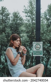 Asian Woman Inhaling And Cigarette Vaping. Female Secretly Smoking In Bathroom At Home. Concept Of Quit Smoking And Anti Cigarette.



