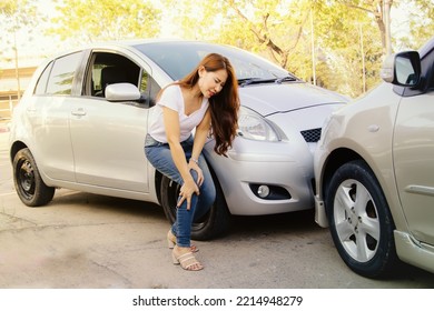 Asian Woman Was Involved In A Car Accident At An Intersection And Suffered Leg And Knee Injuries Knee Pain Unable To Walk With Painful Face Waiting For Help From An Insurance Company Representative.