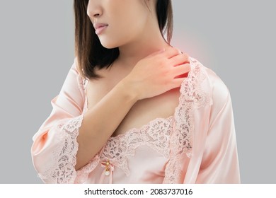 Asian Woman Itchy Neck And Shoulder On A Gray Background