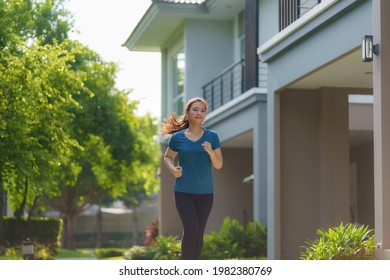 Asian woman are jogging in the neighborhood for daily health and well being, both physical and mental and simple antidote to daily stresses and to socialize safely.