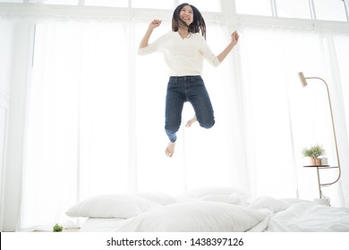 Asian Woman Jumping On The Bed. Happy Concept