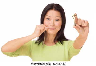 Asian woman keep mouth locked with key isolated on white