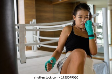 Asian Woman Kick Boxer Ready For Kicking At Gym