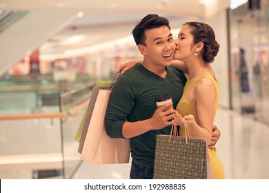 Asian Woman Kissing Her Boyfriend In The Store