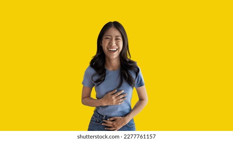 Asian woman laughing happily on yellow background, Happiness through laughter, Funny, Copy space, Portrait, Advertising text area, Isolated on yellow background. - Shutterstock ID 2277761157