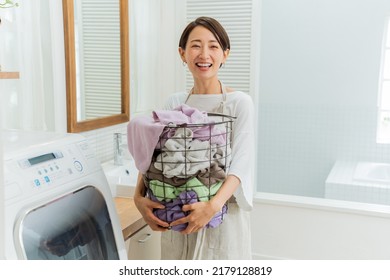 Asian Woman With Laundry In The Room