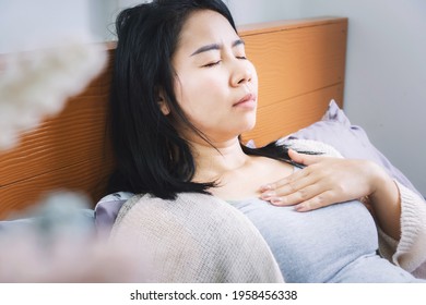 Asian Woman Laydown In Bed Having Problem With Heartburn From Acid Reflux Difficult To Breathe After Wakeup In Morning 