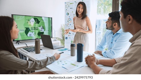 Asian woman lead young group of multiethnic businesspeople in team meeting, using laptop computer for ESG topic presentation on monitor. Sustainable business practice, people work at home concept - Powered by Shutterstock