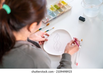 Asian Woman Learning Color Painting Her Self-made Pottery Plate At Home. Confidence Female Relax And Enjoy Handicraft Activity Lifestyle Hobbies Ceramic Sculpture Painting Workshop At Pottery Studio