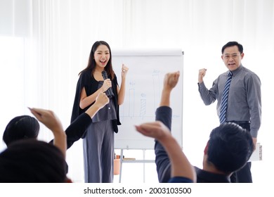 Asian woman Lecturer is lecturing about business and stock market topics and businesspeople are build powerful for success in the knowledge in the economics class in meeting room at university.