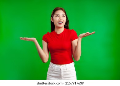 Asian Woman Long Hair In Red Shirt Standing On The Green Screen Background.