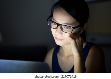 Asian Woman Look At Computer Screen At Night