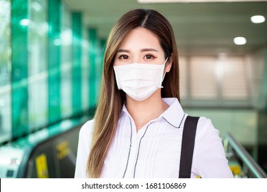 Asian woman look you with surgical mask face protection in the metro or train station - Powered by Shutterstock