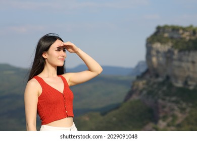 Asian Woman Looking Forward Protecting From Sun With Her Hand In The Mountain