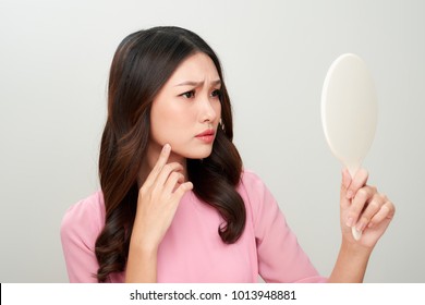 Asian Woman Looking At The Mirror With The Trouble On Her Skin.