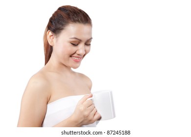 Asian woman looking and smiling at her cup
