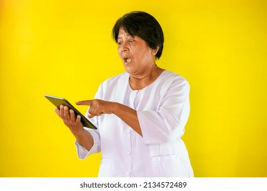 Asian Woman Looking At Split Screen On Yellow Background