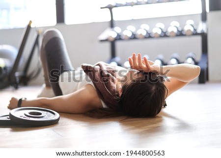 Asian woman lying down in the training gym
