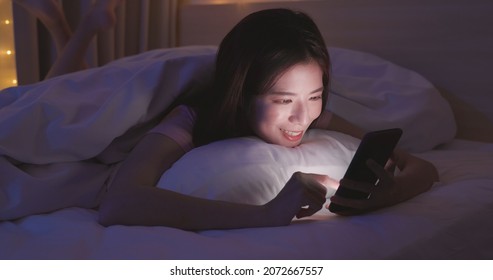 looking at phone in bed