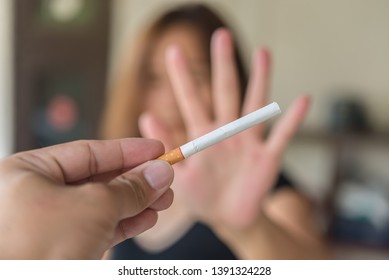 Asian Woman Make Hand Refuse  Cigarette.Quitting From Addiction Concept,No Tobacco Day,No Smoking Concept,Just Say No