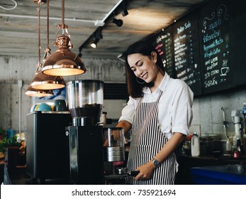 Asian Woman Making Coffee In Cafe