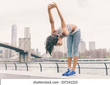 Asian Woman Making Stretching In New York. Runner Making Exercises Early In The Morning On The Pier