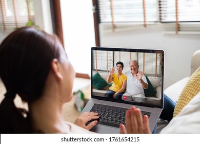 Asian Woman Making Video Call Virtual Meeting With Family