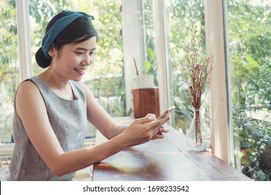 Asian woman making video calling with smartphone at home,  work from home remotely, hybrid working concept - Powered by Shutterstock