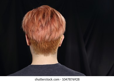 Asian Woman Man Before Applying Make Up Hair Style. No Retouch, Red Peach Hair Color. Studio Lighting Black Dark Fabric Background, Rear Side Back View Head Only