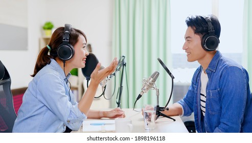 Asian Woman And Man With Microphone Are Recording Podcast At Studio