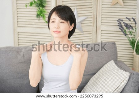 Asian woman massage the neck at home