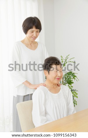 Asian Woman Massages The Senior Citizens Shoulders Asian Woman Massages The Senior Citizens Shoulders
