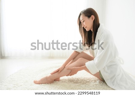 Asian woman massaging feet and grooming hair removal 