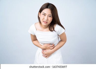 Asian woman with menstruation feels very painful on her stomach Isolated on white.