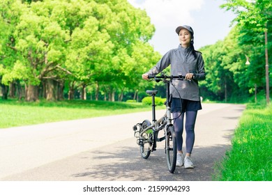 Asian Woman With Mini Velo Bicycle. Cycling In Nature.