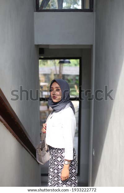 asian woman muslim hijab fashion\
standing at interior house. penang malaysia. march 07,\
2021