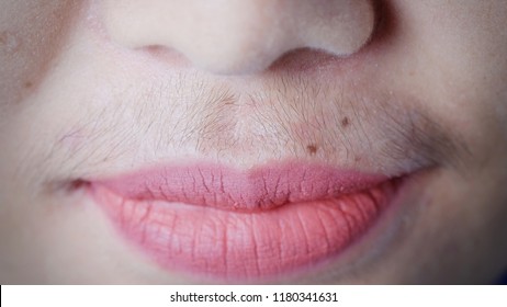 Asian woman mustache.Closeup.