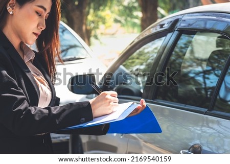 Asian woman notify insurance agents is writing an accident car crash report, to people and transportation insurance concept.