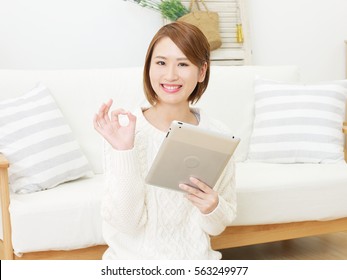 Asian Woman OK Gesture With Tablet