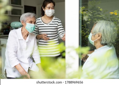 Asian Woman And Old Elderly With Medical Masks On The Face,daughter Talking Happily Visited Her Senior Mother At Home,wear A Protective Face Mask For Safety While Close To Each Other,New Normal Life