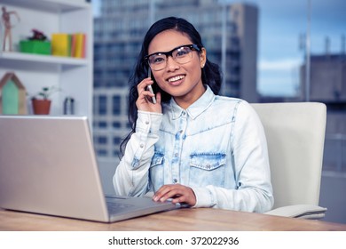 Asian woman on a phone call in office - Shutterstock ID 372022936