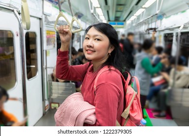 Asian Woman Onboard A Train On The Seoul Underground Rail System.