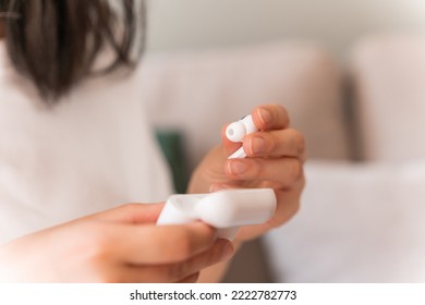 Asian Woman Opening Box With Earphones While Preparing For The Video Conversation