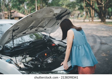 Asian Woman Opening Car Hood And Look For Trouble Car Breaks Down And Wating For Insurance Or Someone To Help After The Car Breaks Down, Park On The Side Of The Road. Transportation Accident Concept.