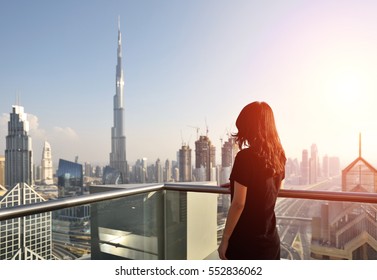 Asian woman overlooking the cityscape of Dubai - Powered by Shutterstock