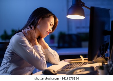 asian woman overtime work and feel shoulder pain in the office - Shutterstock ID 1419378134